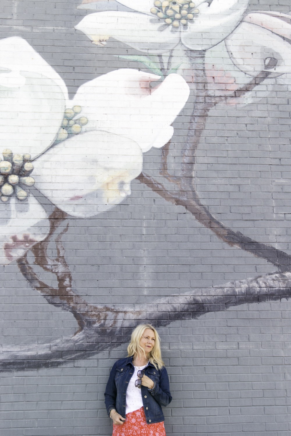 woman in front of mural wall