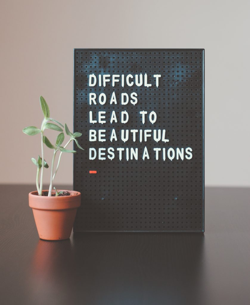 board with quote with small plant