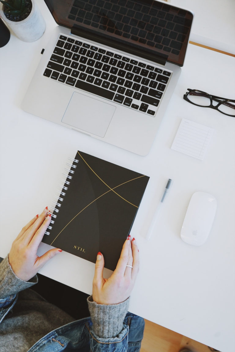 counselor at a desk with journal and laptop